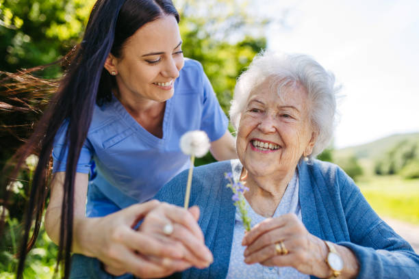Caregiver serving meal to senior